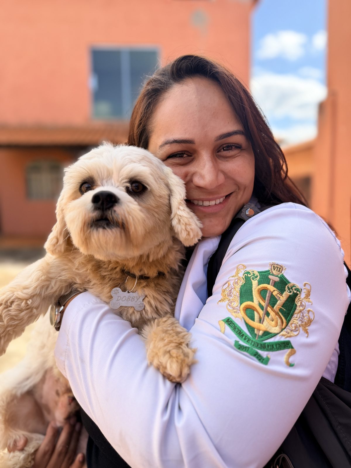 Veterinária da Vetconfort segurando um cão no colo com carinho